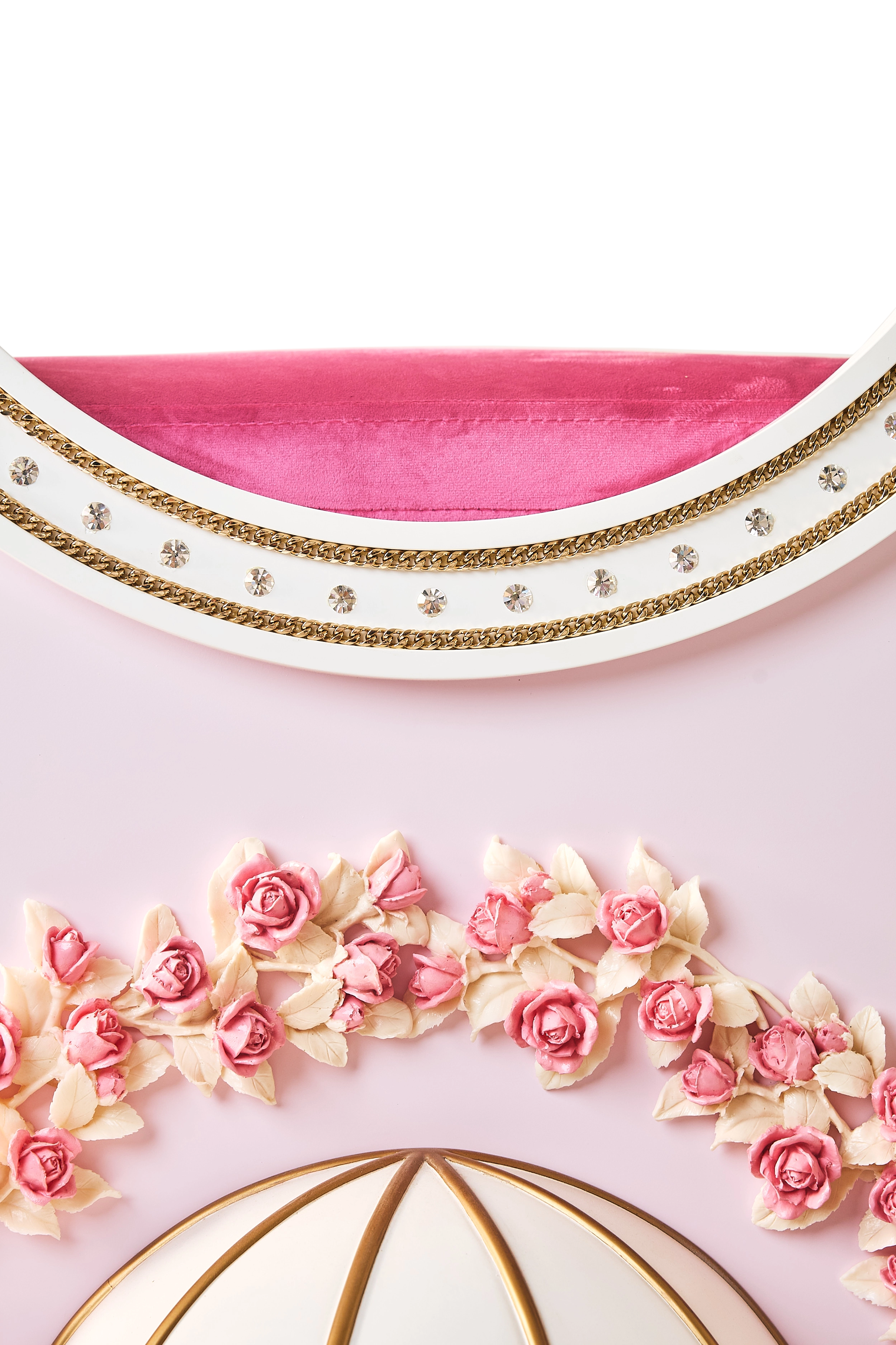 Close-up of the FUROAR Bella luxury cat villa upper trim featuring sparkling crystal embellishments, gold chain borders, and a plush pink velvet top.