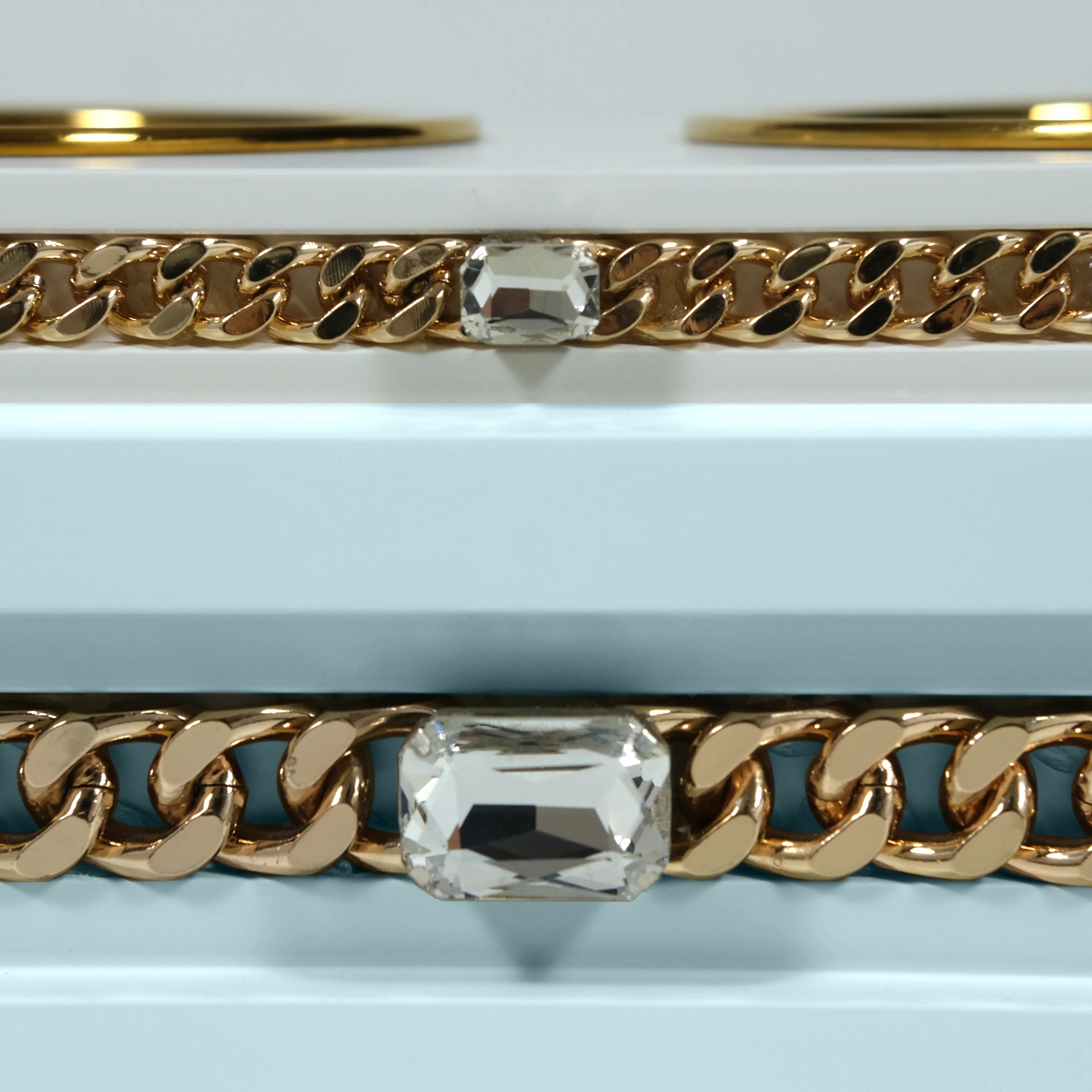 "Close-up detail of the jewelry-grade crystal and haute couture chain application on the FUROAR Milo modern designer station."