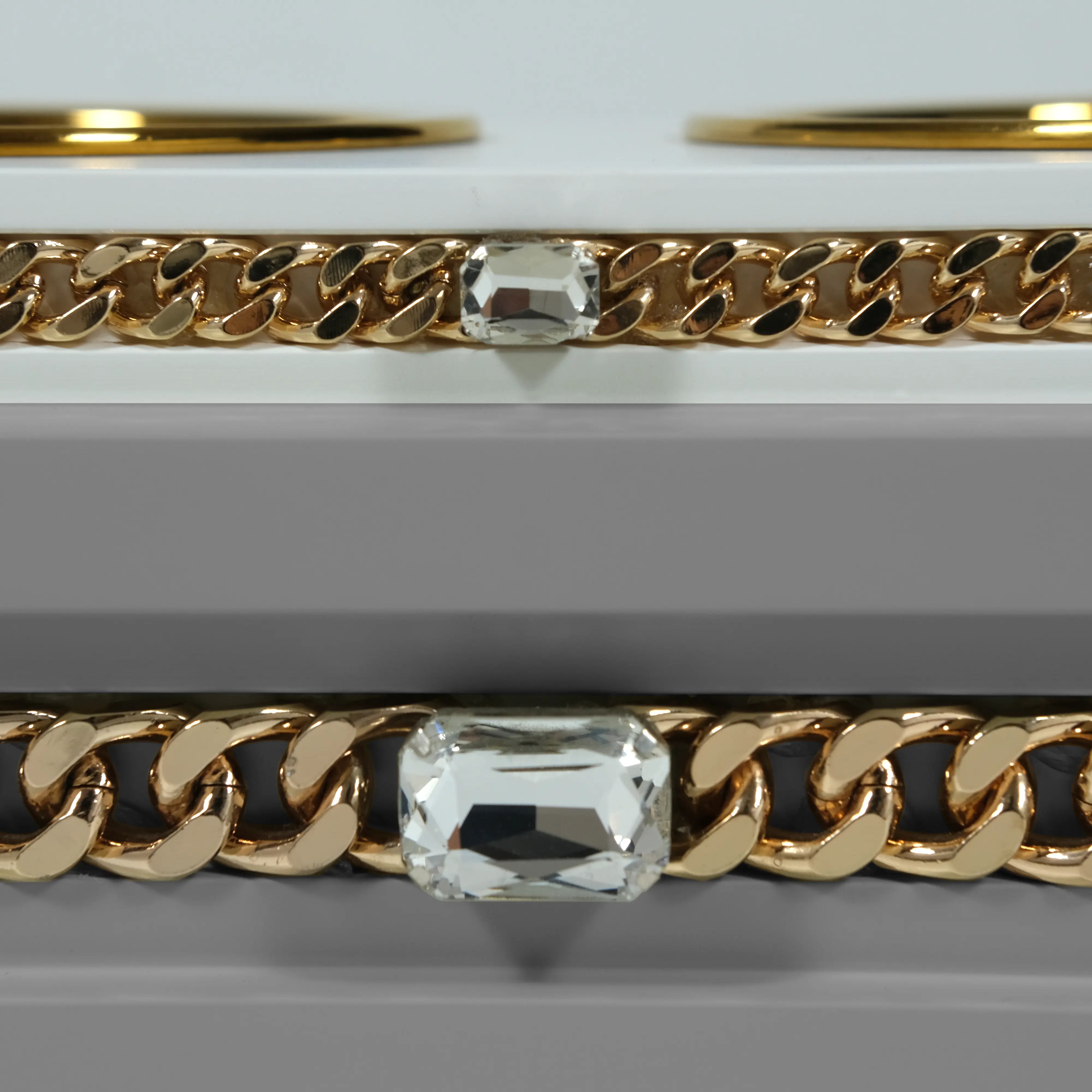 "Close-up detail of the jewelry-grade crystal and haute couture chain application on the FUROAR Princo modern designer station."