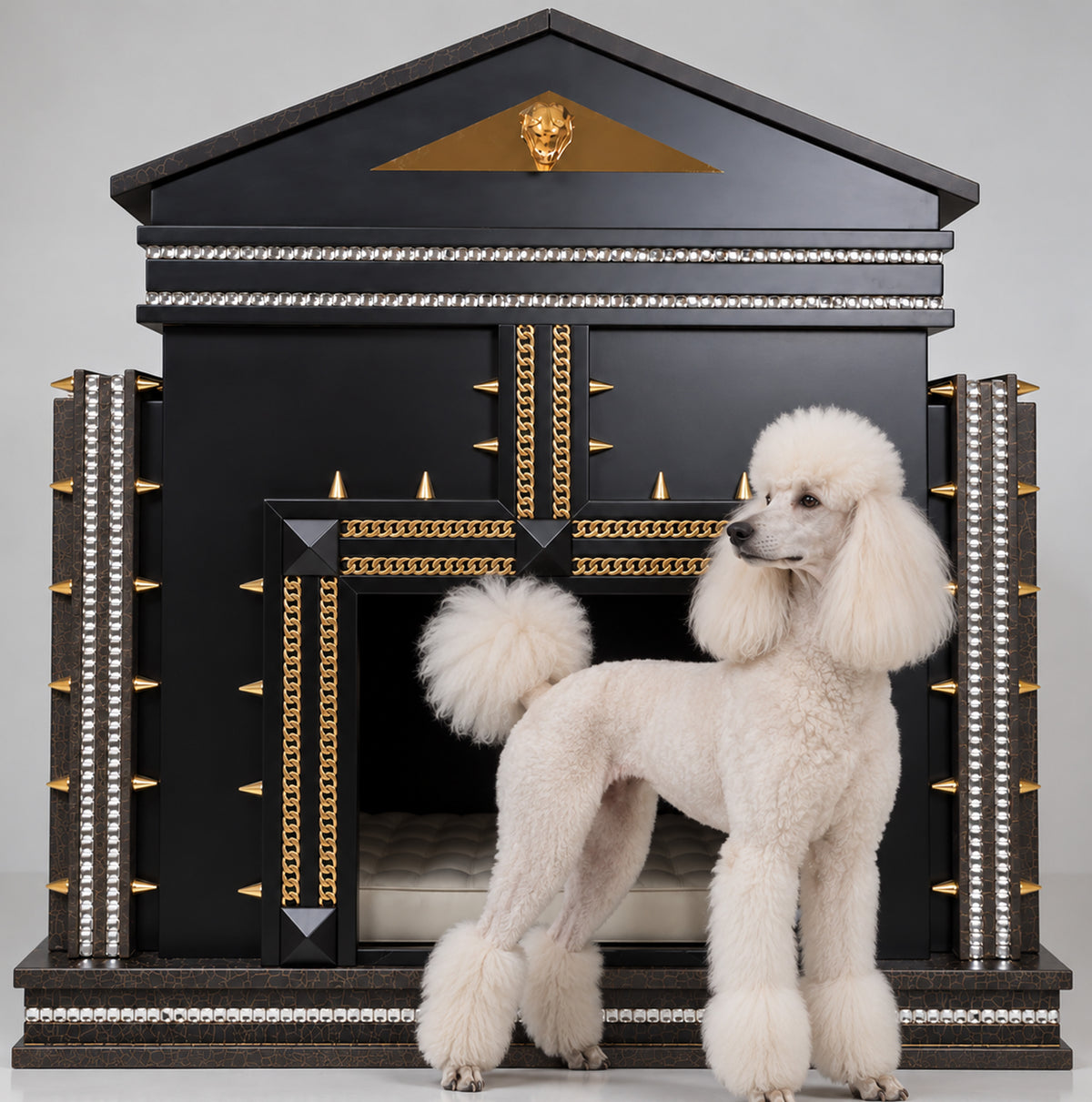 White manicured French Poodle standing in profile in front of a black and gold FUROAR luxury dog house, featuring crystal detailing, gold chains, architectural accents and a plush interior.