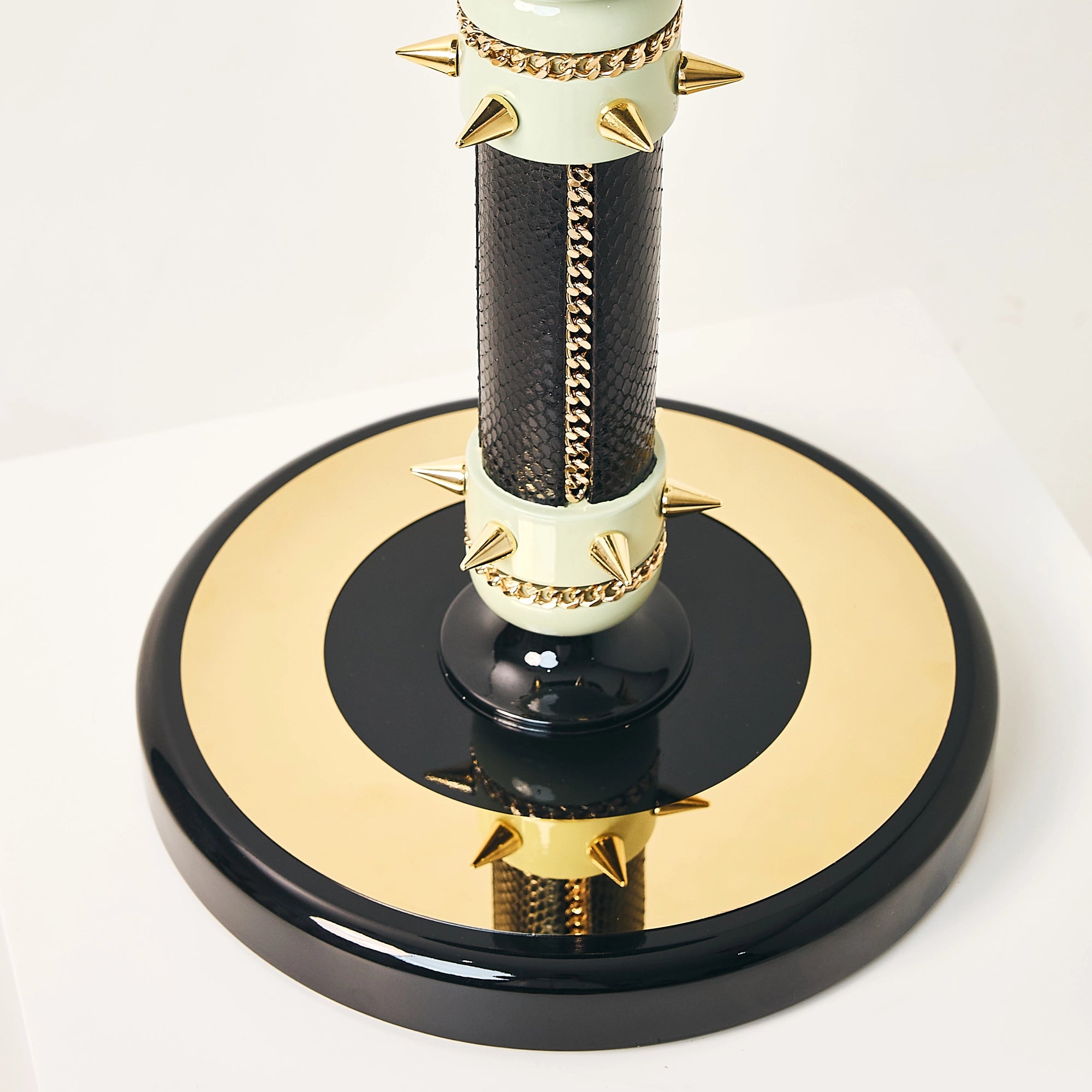 Polished gold base detail on the FUROAR Empress falcon perch.