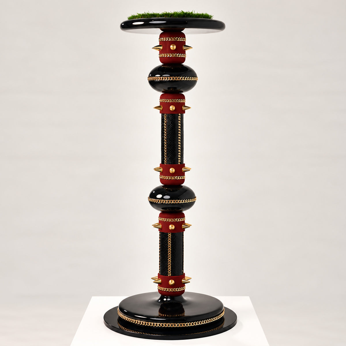 VIZIAR , The Crowned Pedestal Falcon Perch by FUROAR, featuring a sculptural black and deep burgundy design with polished gold chain detailing, gold accents and a grass-topped falcon platform.