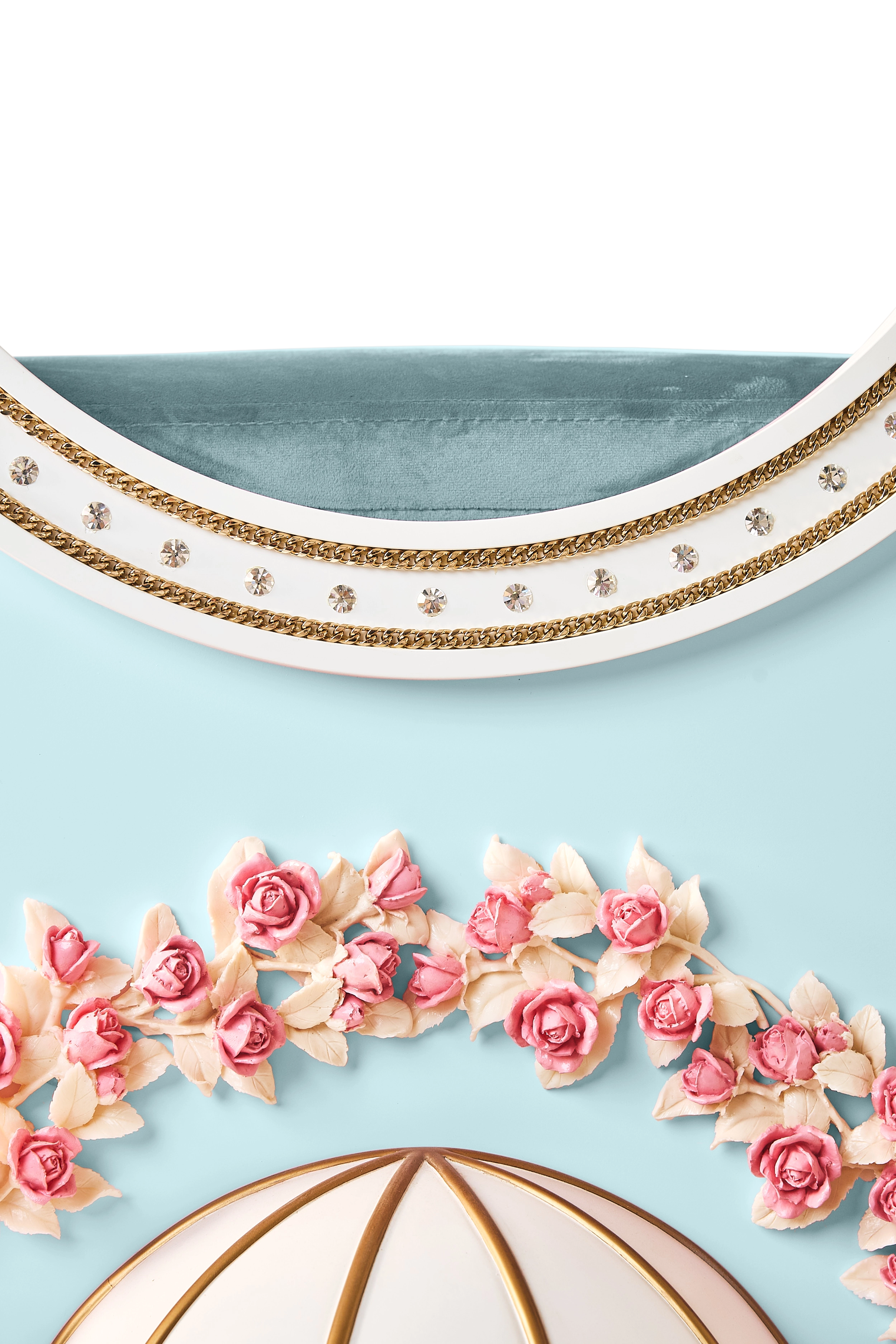 Close-up of the FUROAR luxury light blue cat villa upper trim featuring sparkling crystal embellishments, gold chain borders, and a plush teal velvet top.