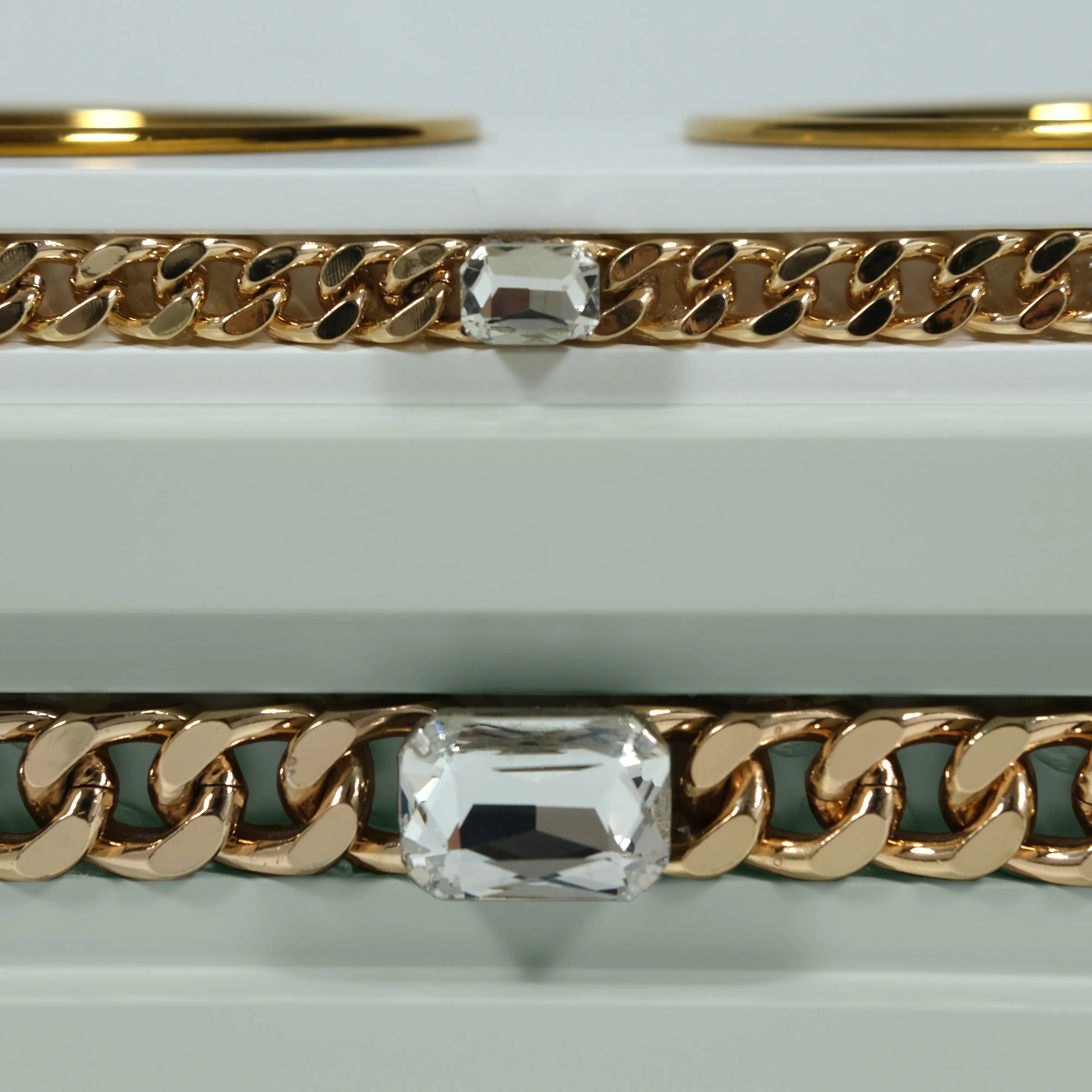 "Close-up detail of the jewelry-grade crystal and haute couture chain application on the FUROAR Minsky modern designer station."