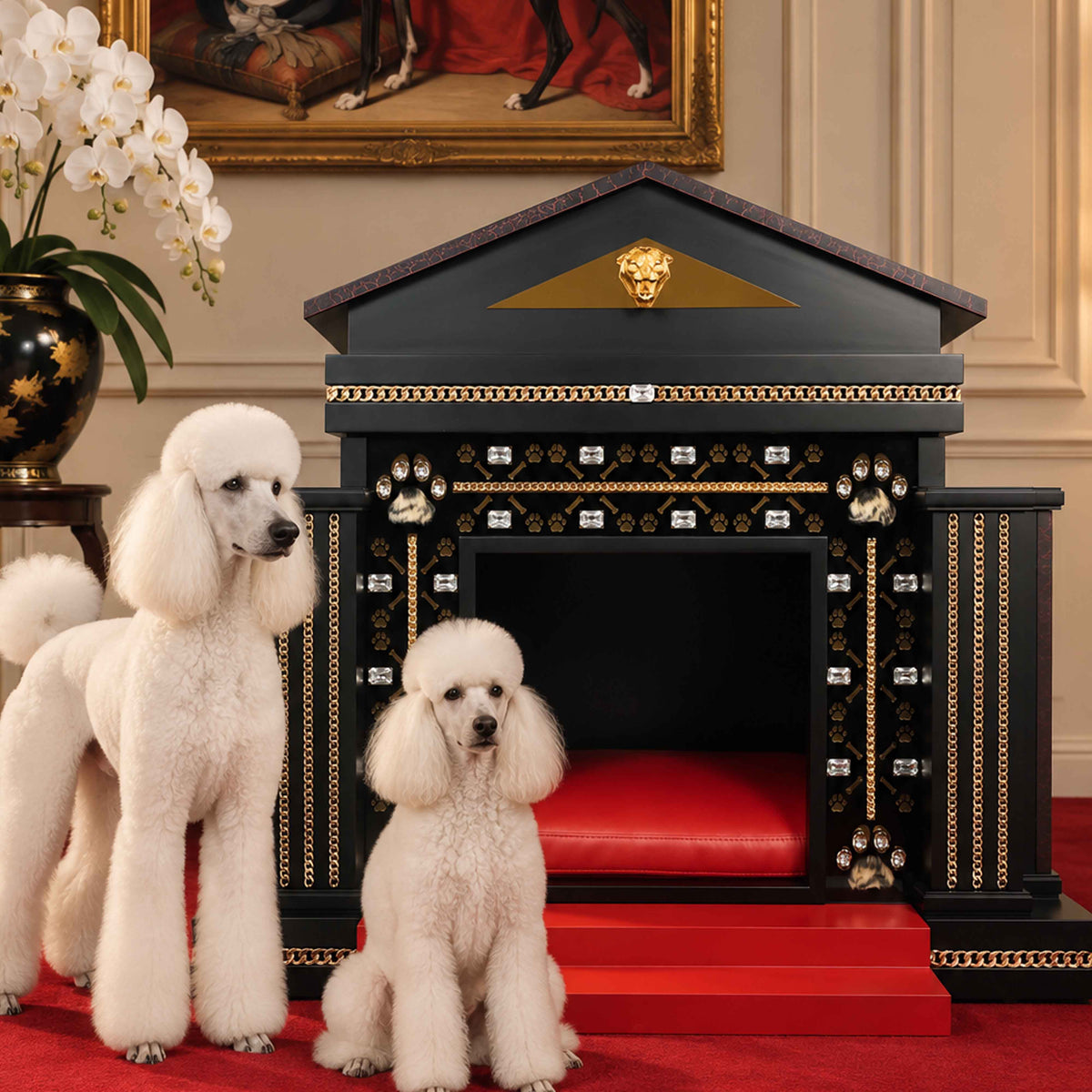 Two elegant white French Poodles posed beside a black, red and gold FUROAR luxury dog kennel, featuring crystal embellishments, gold chain detailing, paw motifs, a red cushioned interior and red entrance steps, styled on a red carpet with white orchids and classic dog portrait artwork.