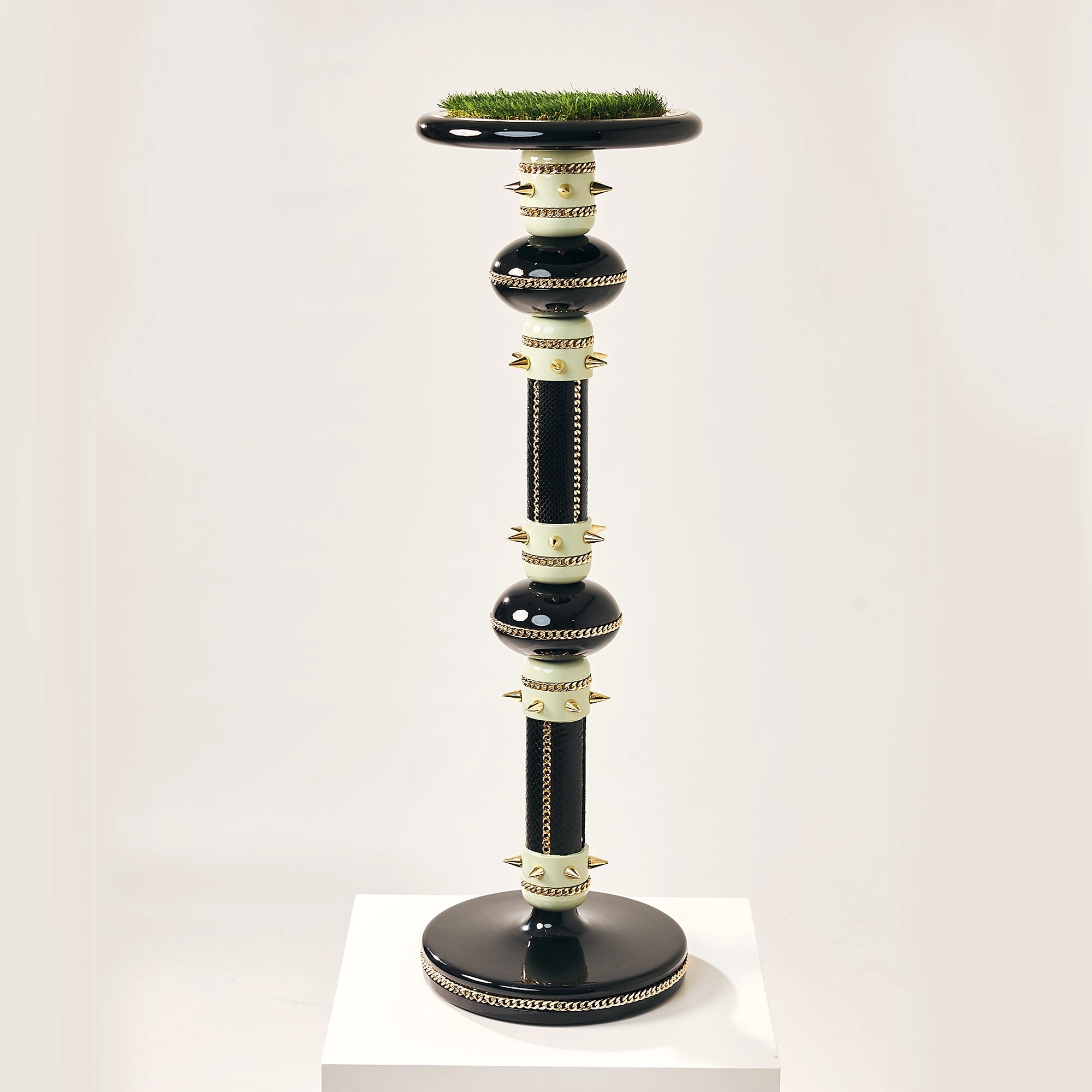 The multi-tiered Majesty falcon stand by FUROAR showing a green grass top and pillars.