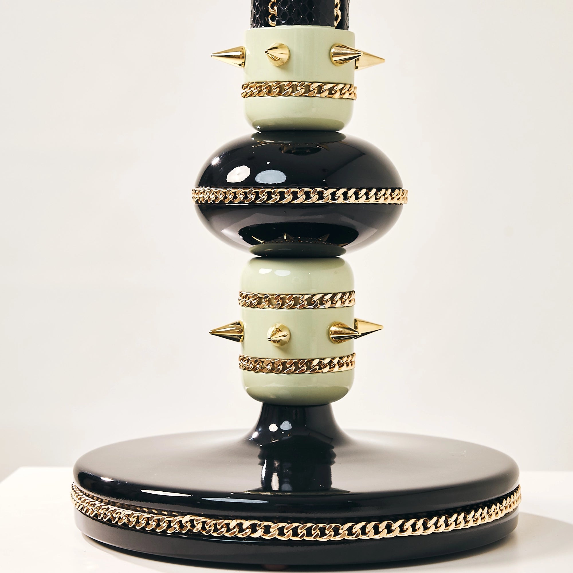Detail of the gold spikes and chain accents on the Victory falcon perch lower base.