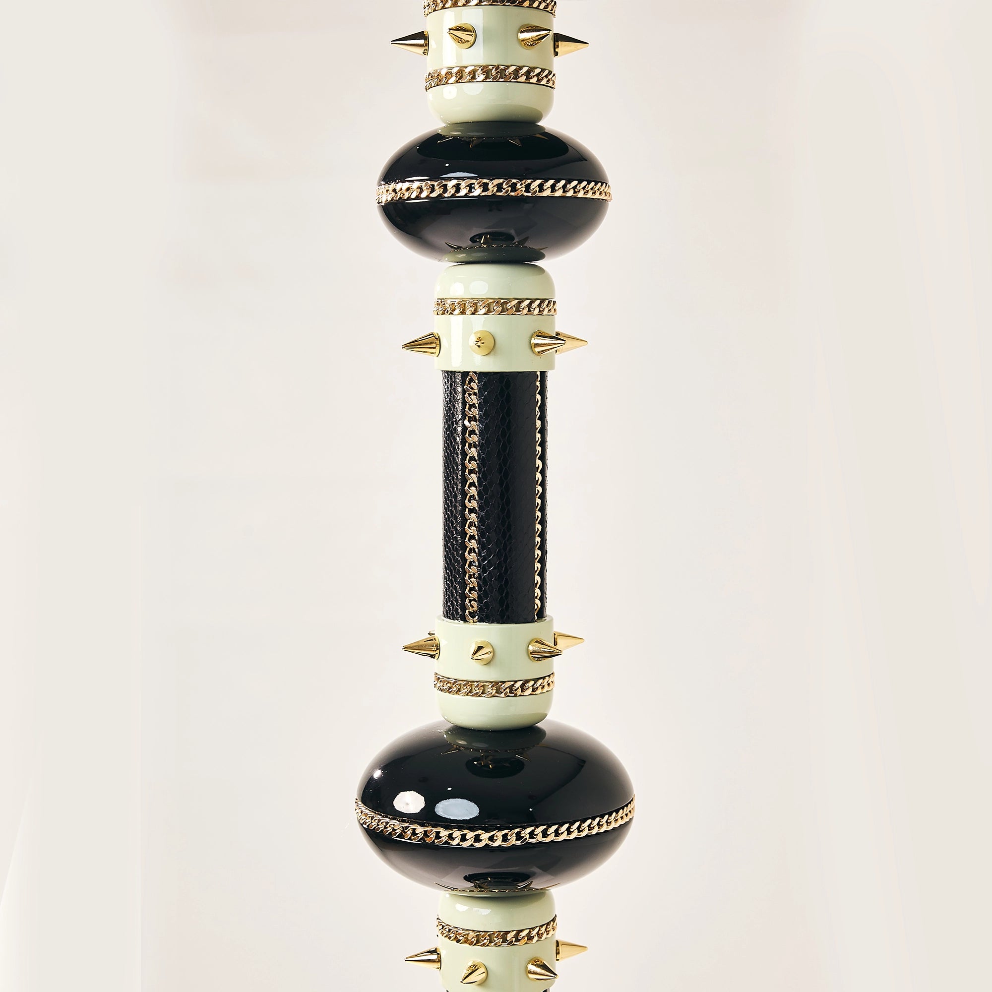 Detail of the reptile-patterned black skin panels wrapped around a falcon perch.
